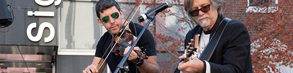 fiddle player and acoustic guitarist performing at Bacon Fest
